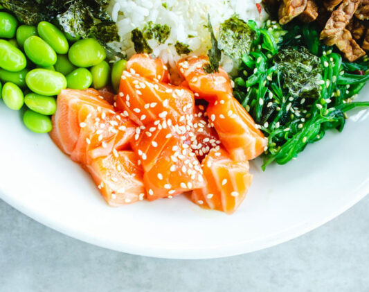 a plate with salmon and vegetables