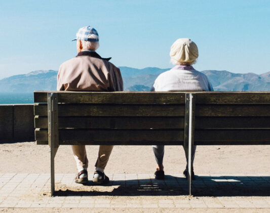 a senior couple sat on a bench