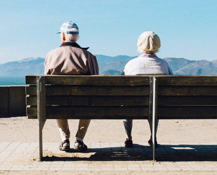 a senior couple sat on a bench