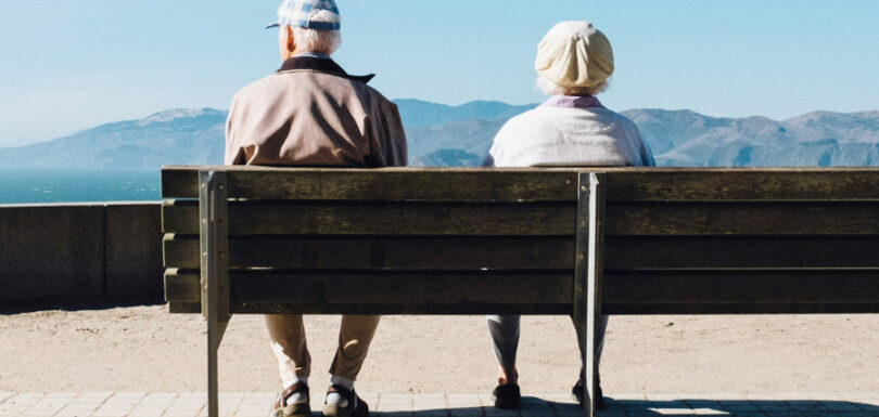 a senior couple sat on a bench