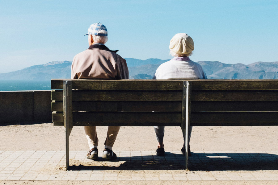 a senior couple sat on a bench